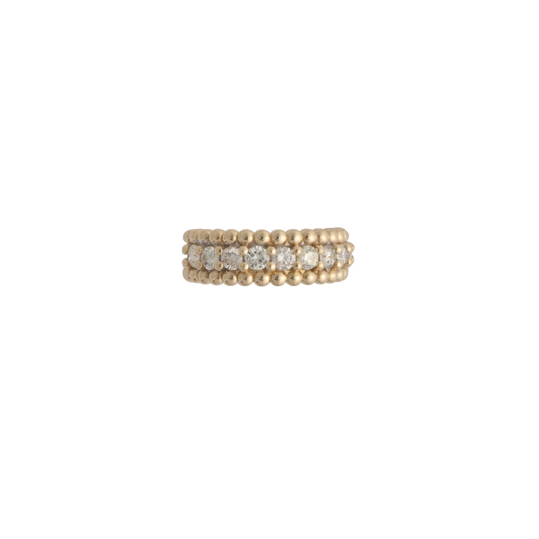 A gold band ring with a beaded edge and embedded with diamonds.