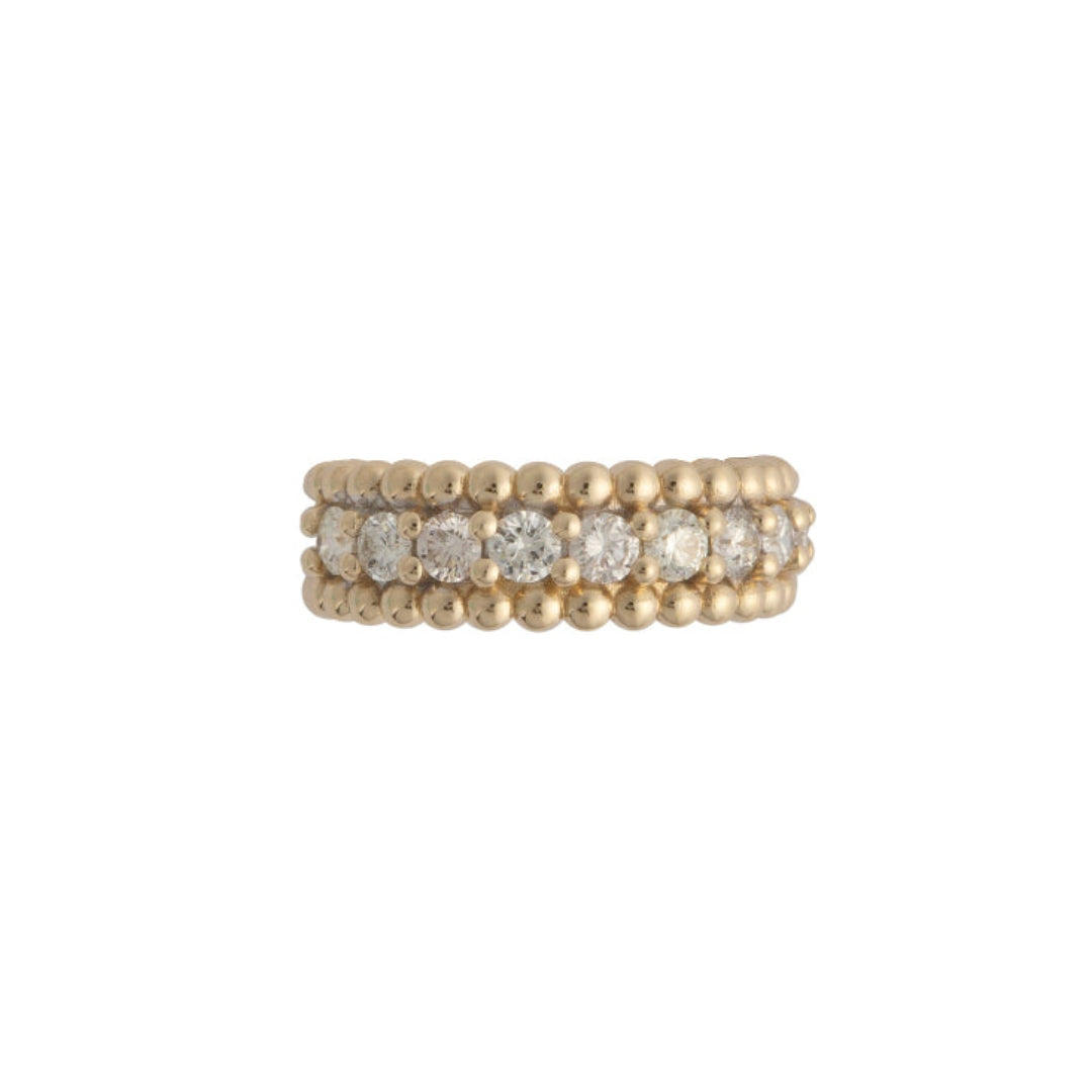 A gold band ring with a beaded edge and embedded with diamonds.