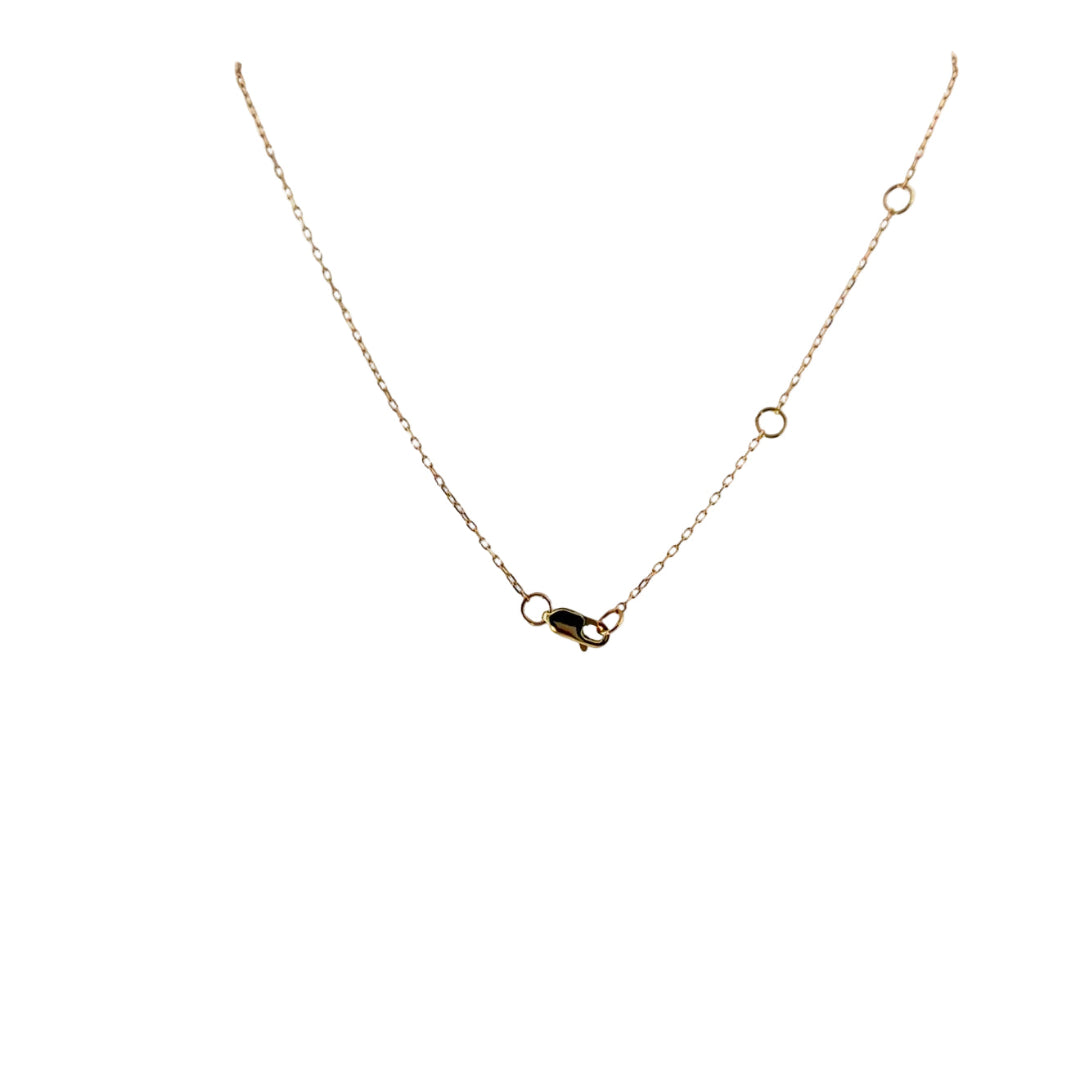 The back of a 14k gold delicate chain, with a lobster clasp and three stations.