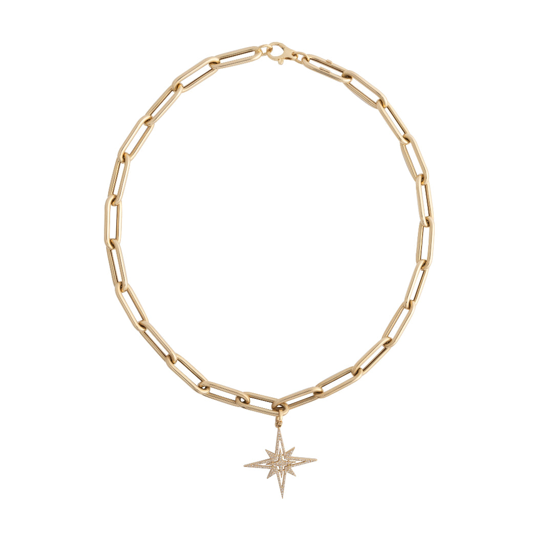 A 14k gold chunky paperclip chain with a pave diamond starburst pendant attached set on a black background.
