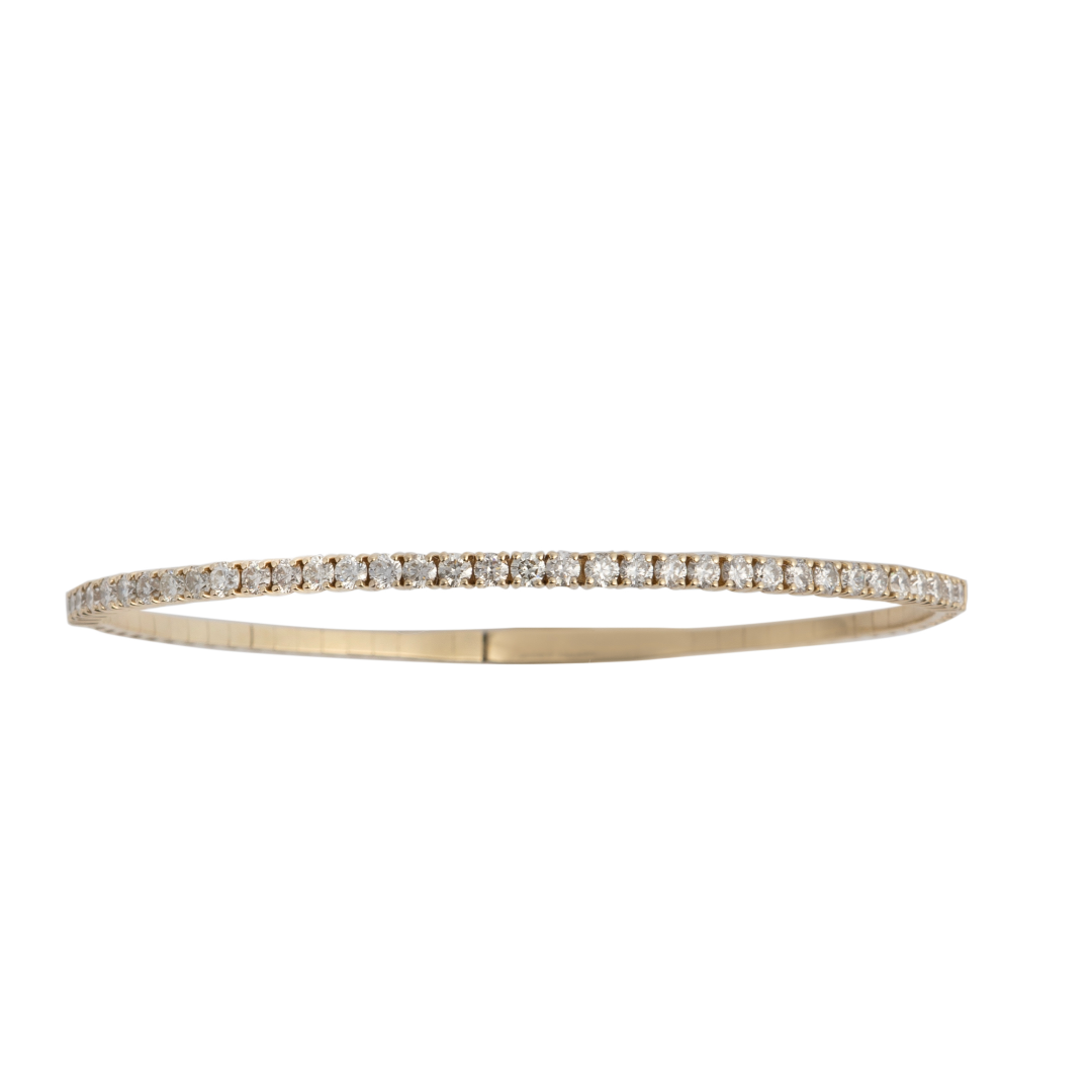 A 14k gold bangle bracelet adorned with diamonds, displayed against a white background.