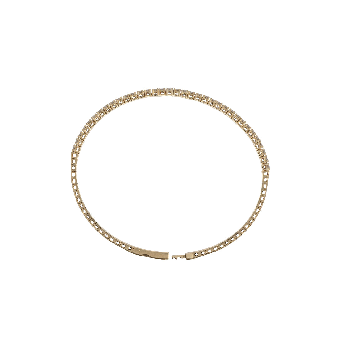 A diamond bracelet sitting sideways on a white background, showcasing the flexible nature of the bracelet and the clasp.