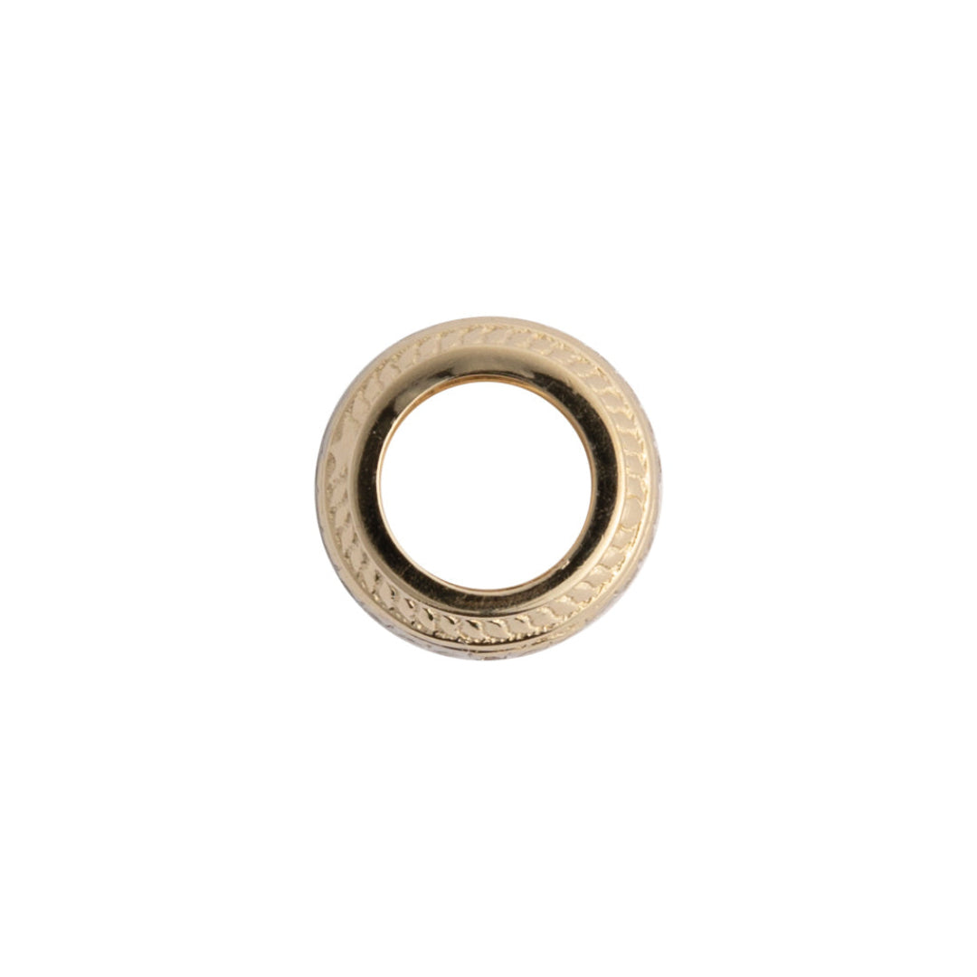 A sideways view of a gold roundel bead featuring a circular design, on a white background.