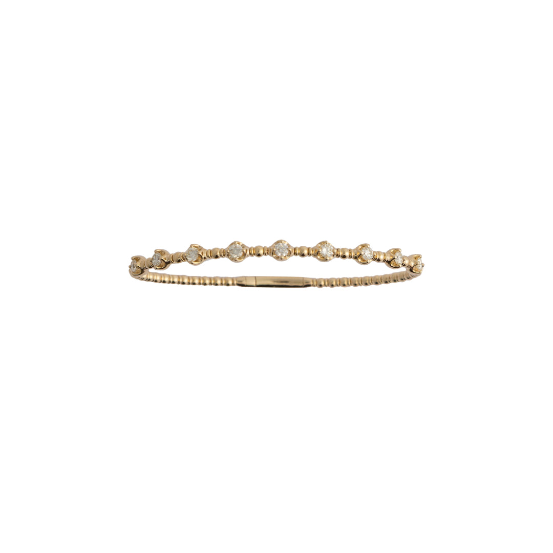 Gold bracelet with small diamonds on a white background