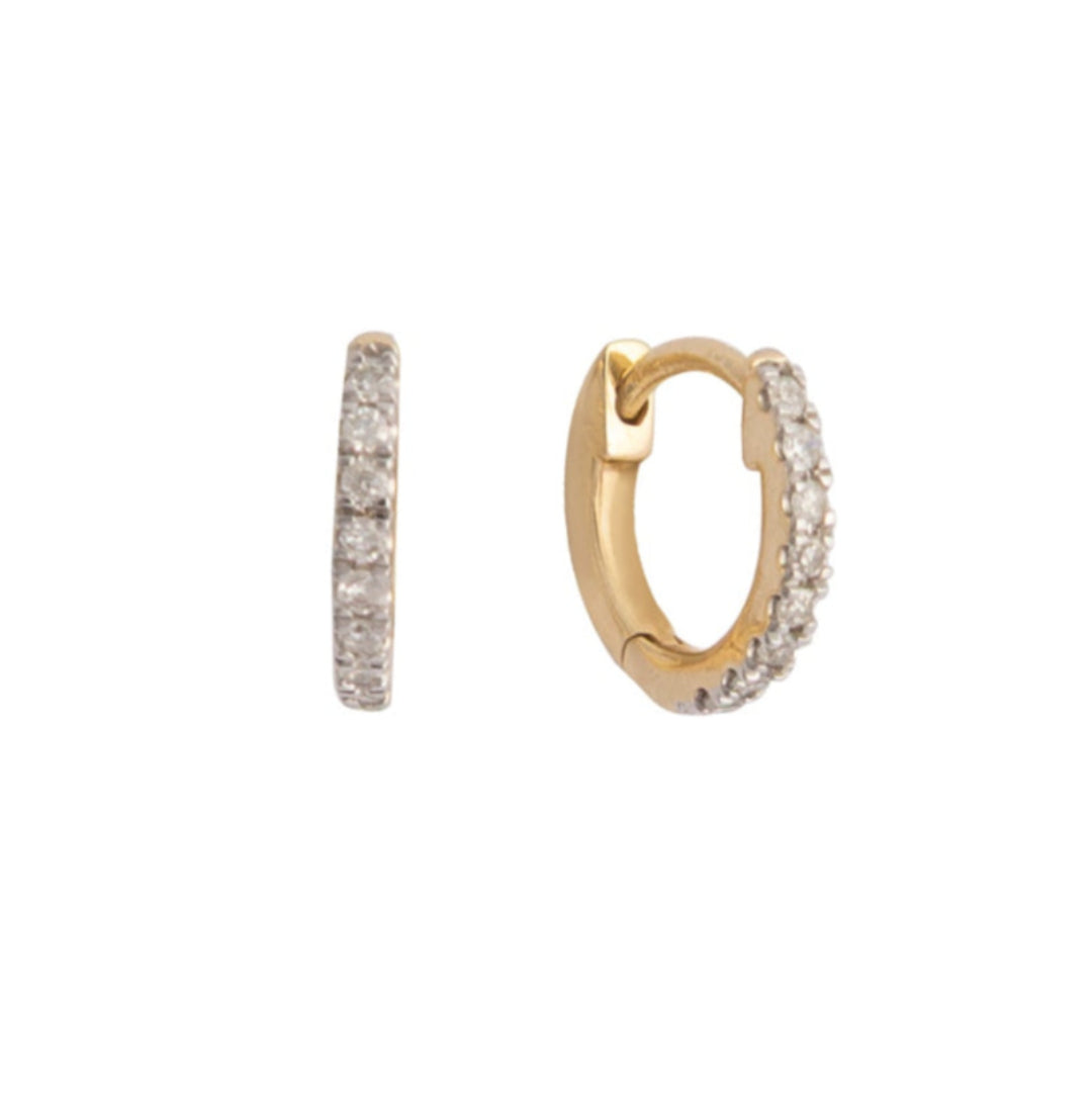 Gold hoop earrings with pave diamonds on a white background