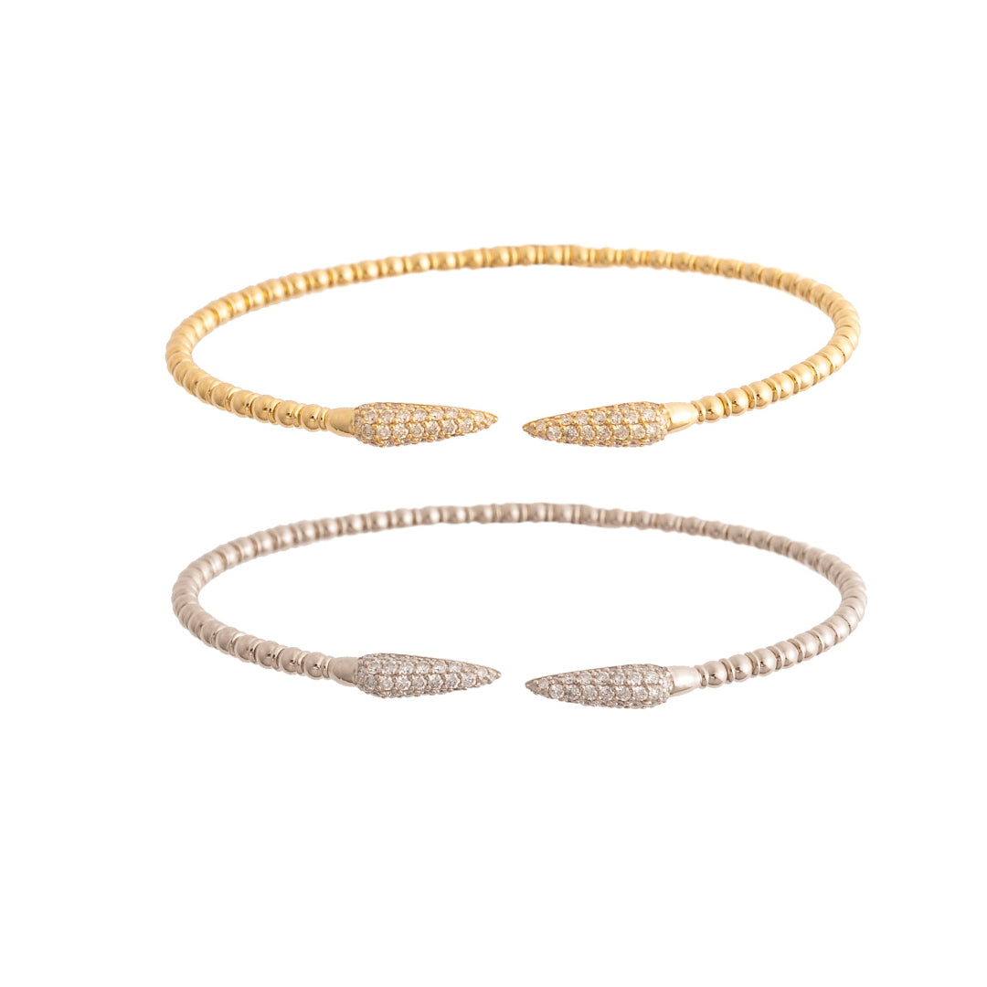 Two flexi bracelets, one yellow gold and one white gold on a white background