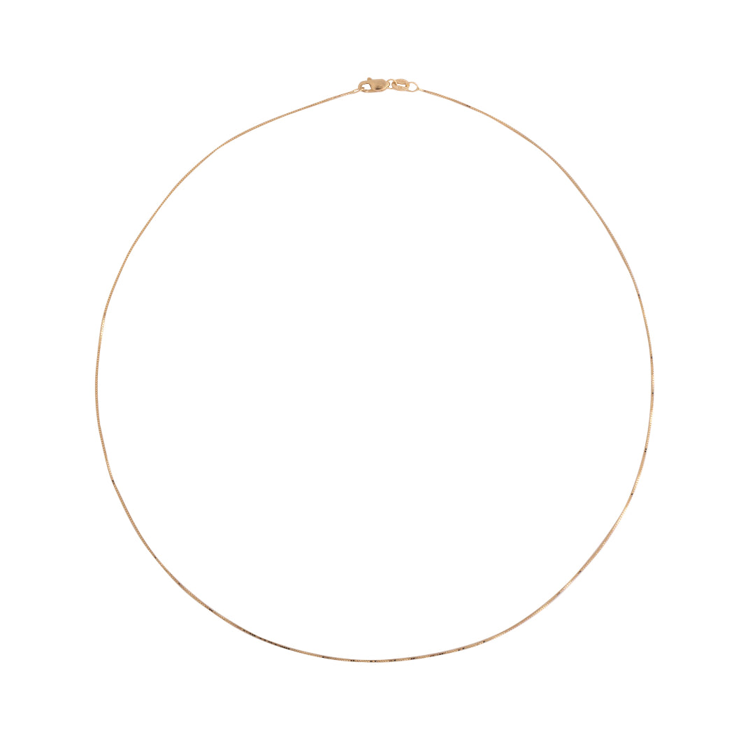 A gold delicate box chain on a white background.