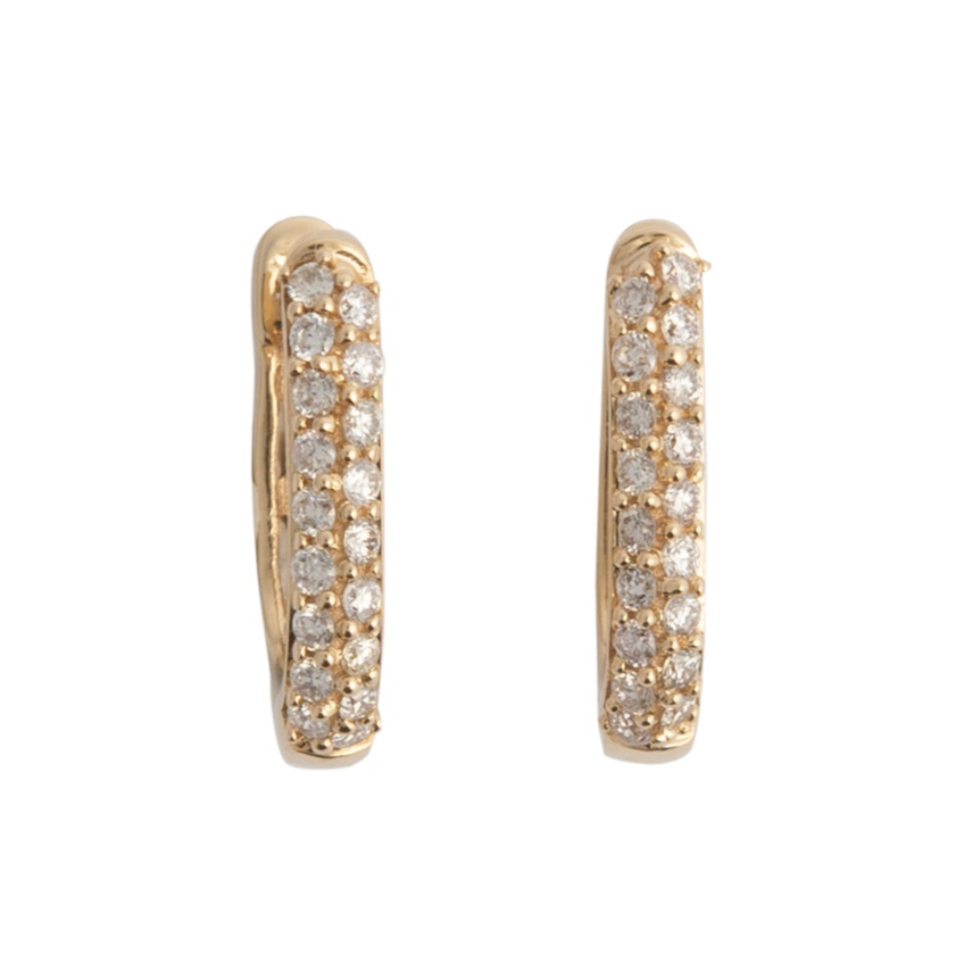 A pair of 14k gold huggie earrings adorned with diamonds.