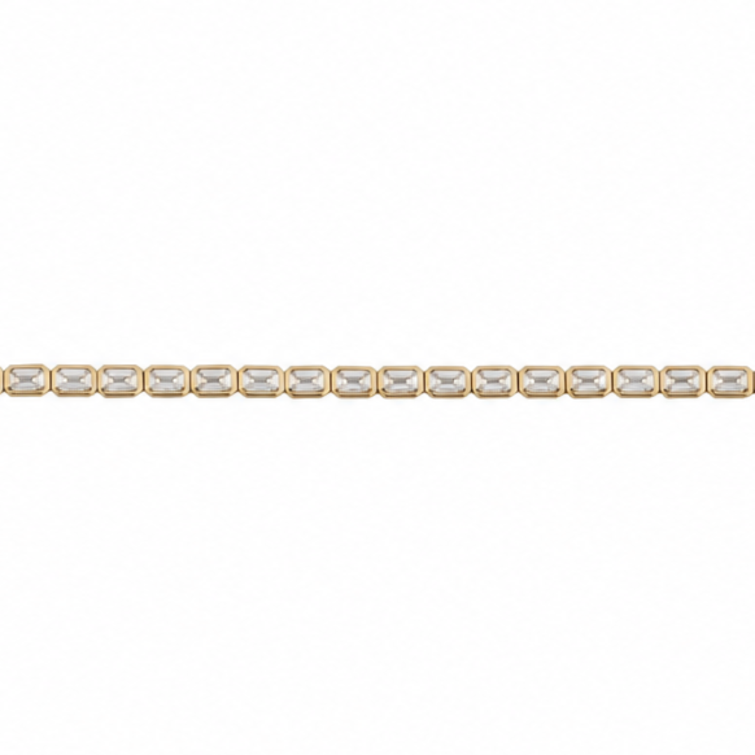 A tennis bracelet with East-West emerald cut lab-grown diamonds set in 14k gold on a white background.
