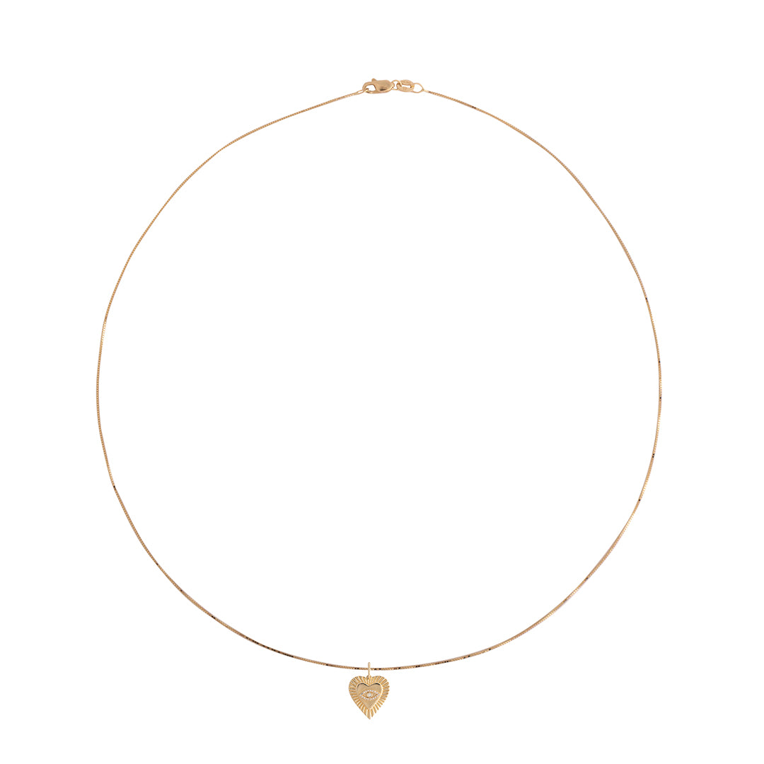 Gold necklace with a heart-shaped pendant on a white background