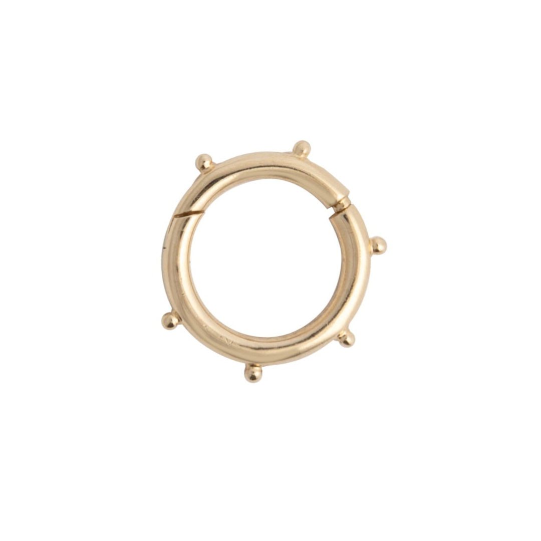 A gold round dotted pendant bail, showcasing the opening feature.