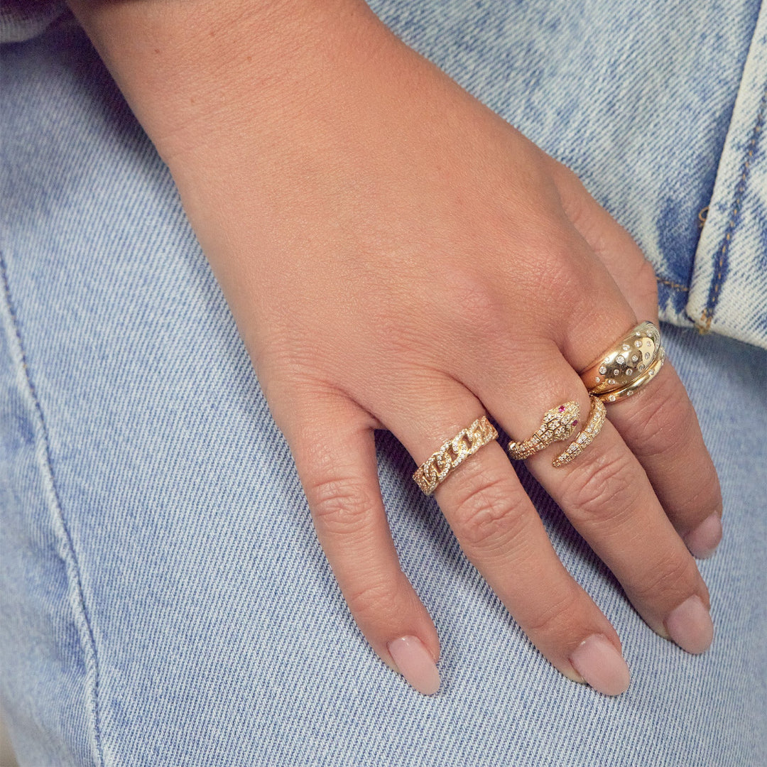 Someone wearing three gold rings.