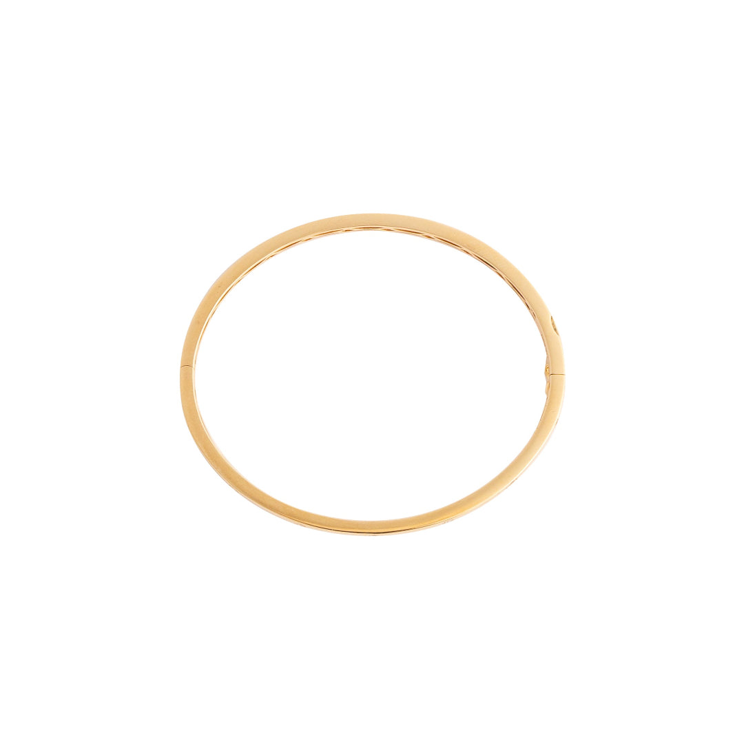 Gold bangle on a white background