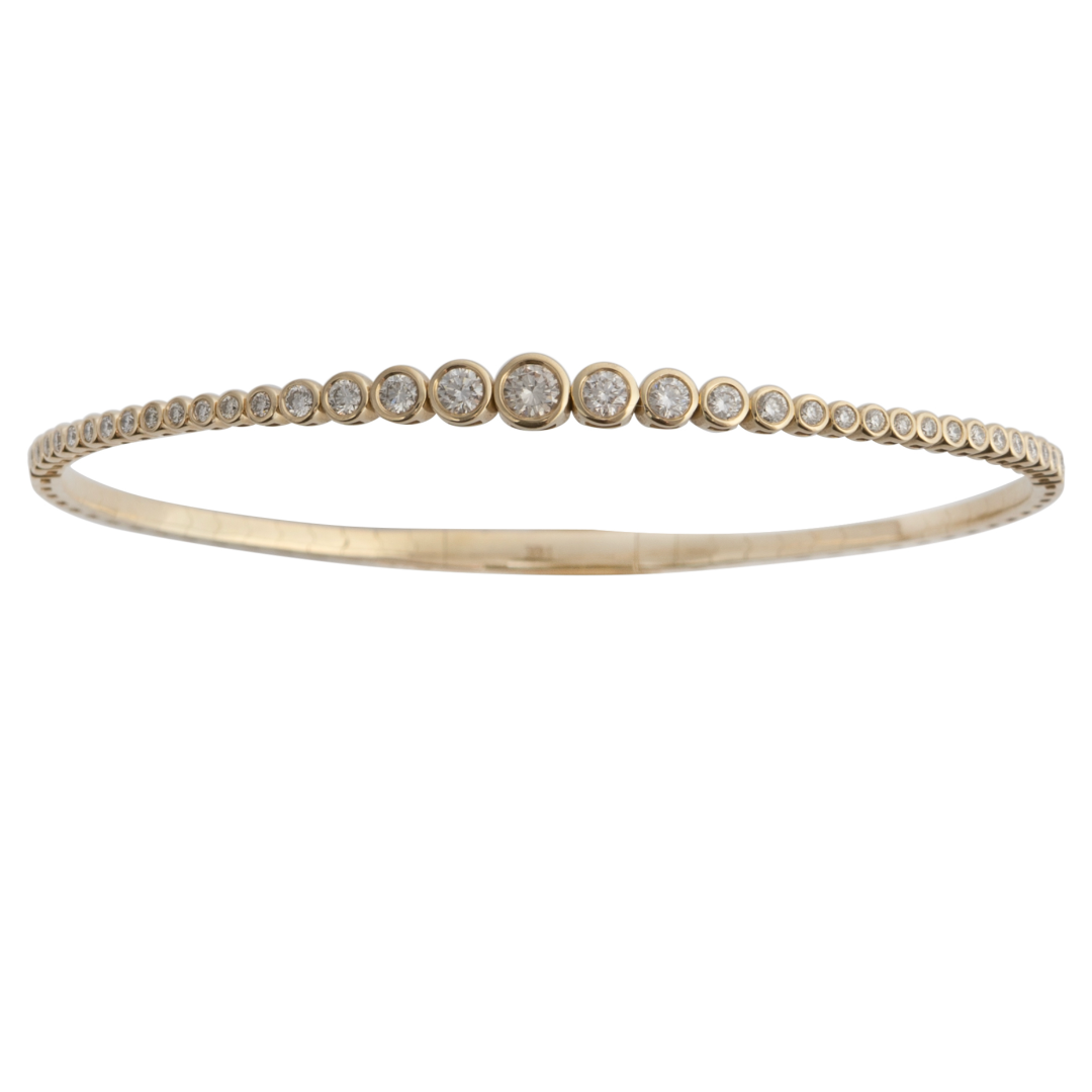 A 14k gold bangle bracelet featuring a series of graduated round diamonds, with a secure clasp on the back.