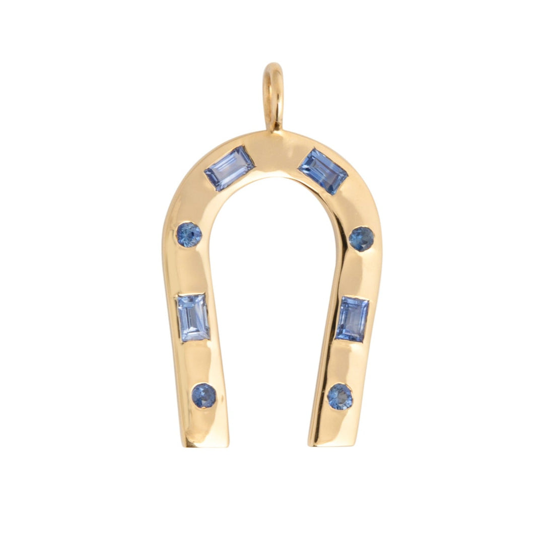 A 14k gold horseshoe-shaped pendant featuring blue sapphires, with a gold chain included.