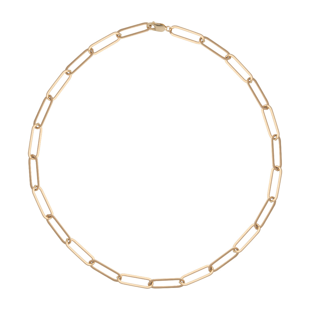 A gold paperclip link chain necklace laid out on a plain background.