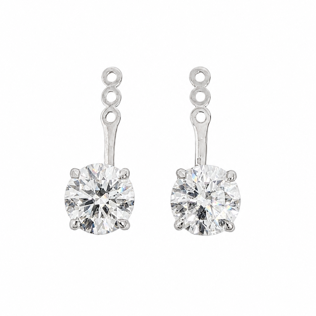 A pair of 14k white gold earring jackets with a three-hole post and a round-cut lab-grown diamond in a four prong setting, shown against a plain white background.