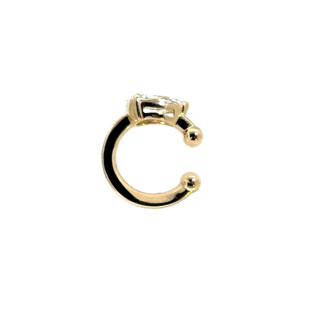 The sideways view of a 14k gold ear cuff with a .75 carat lab-grown diamond on a white background.