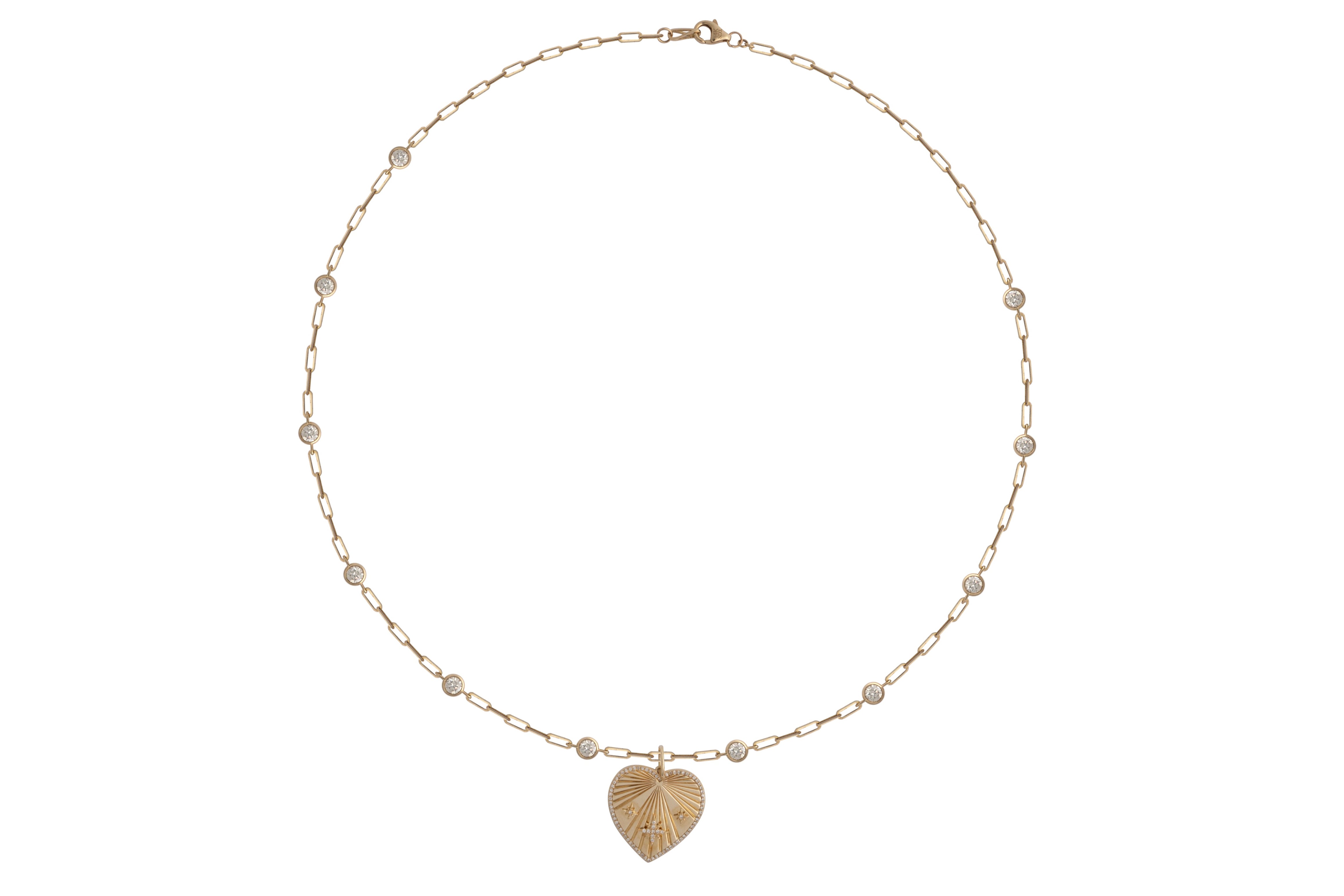 A whitebackground with a 14k gold diamond station paperclip chain necklace and a heart pendant with diamonds.