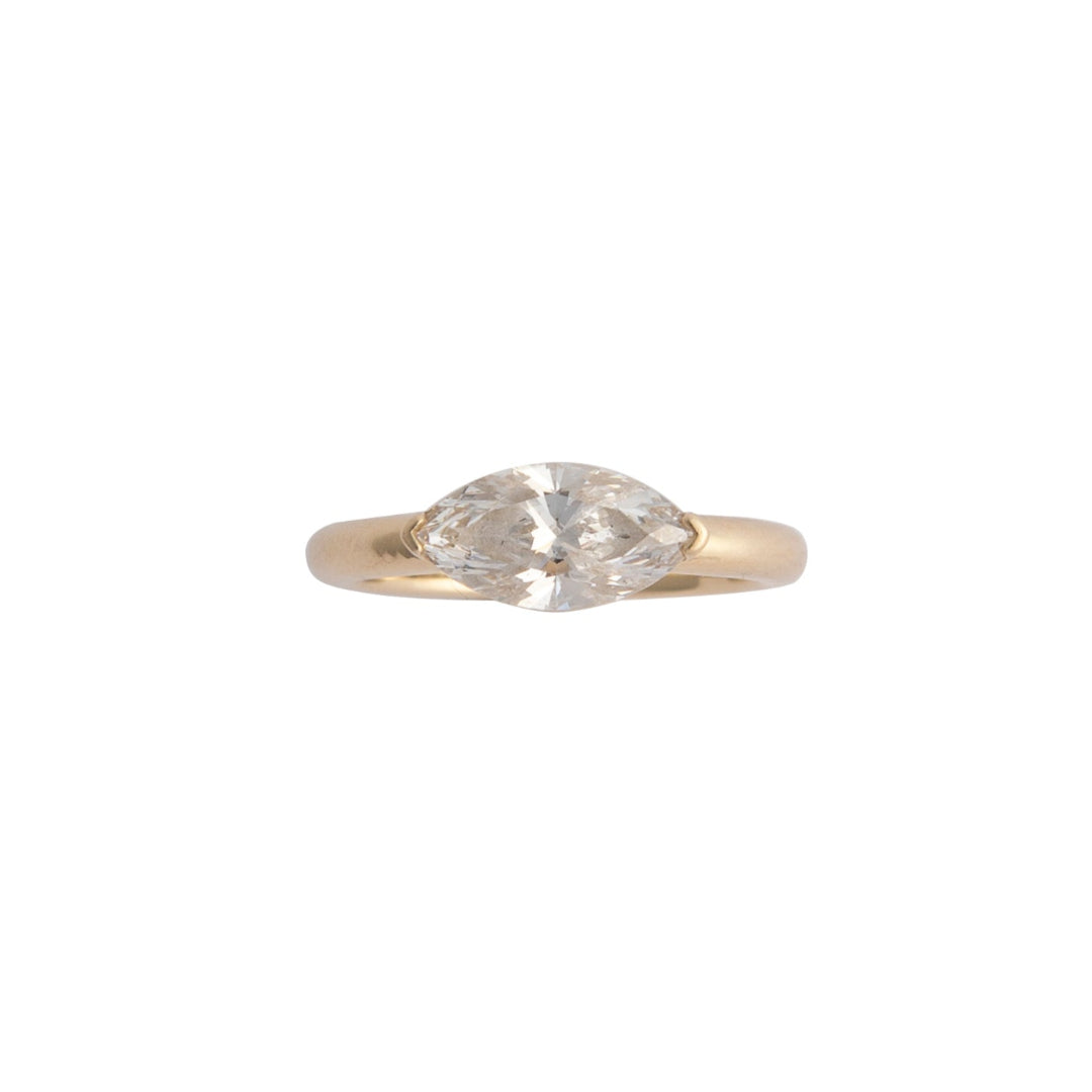 Gold ring with a diamond on a white background