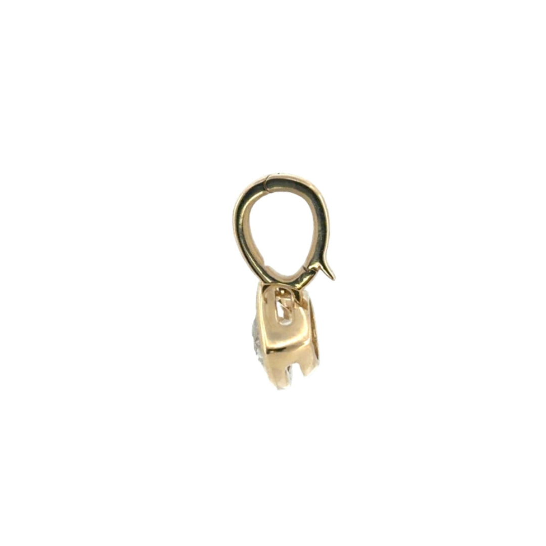 The side view of a 14k gold pendant, showcasing a clip bail. On a white background.
