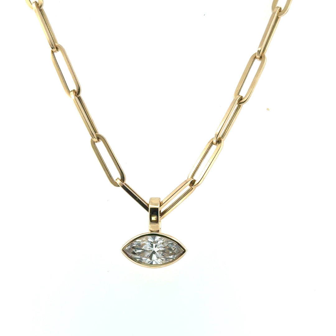 A 14k gold bezel set diamond pendant on a paperclip chain.