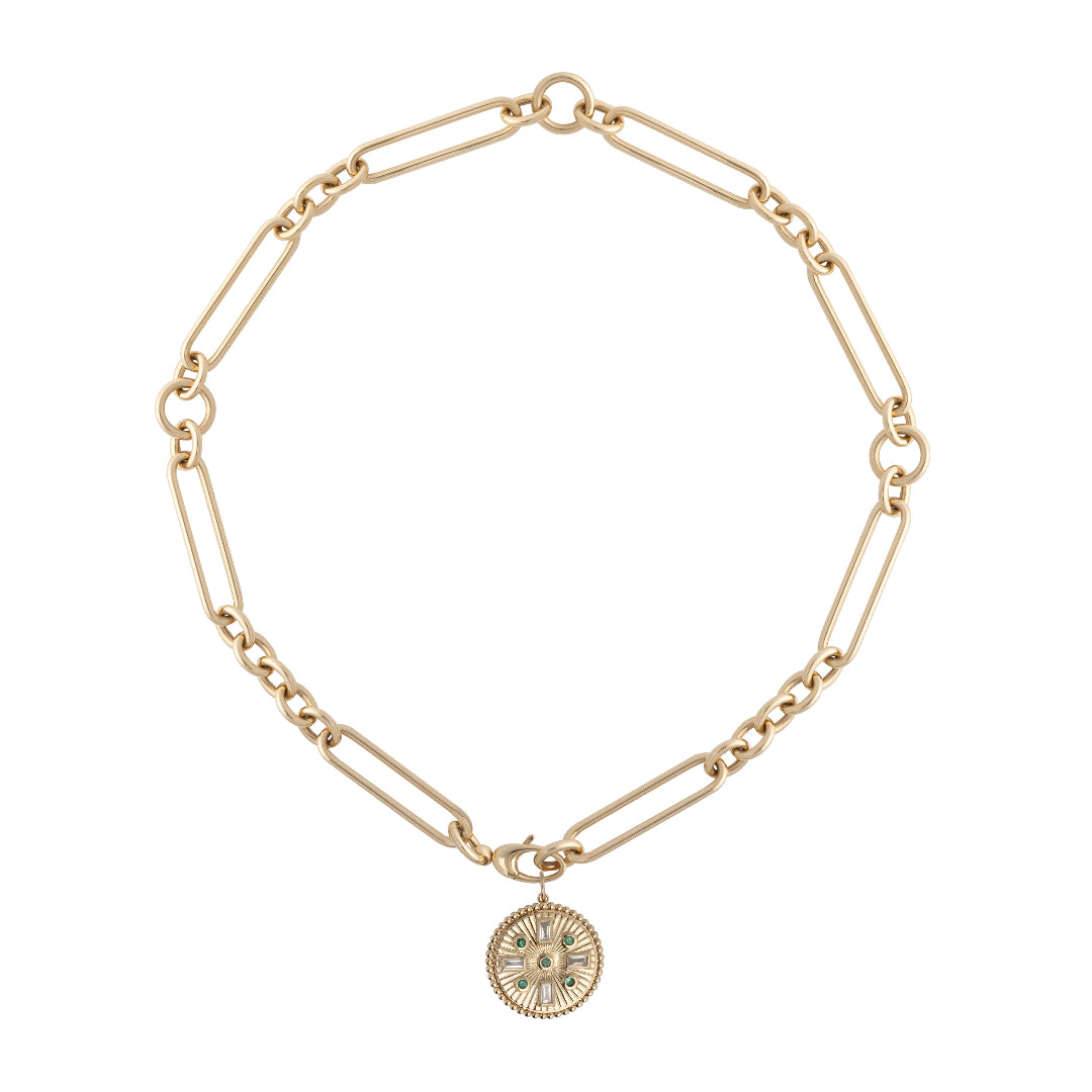 A 14k gold chunky chain with an emerald and diamond pendant attached on a white background.