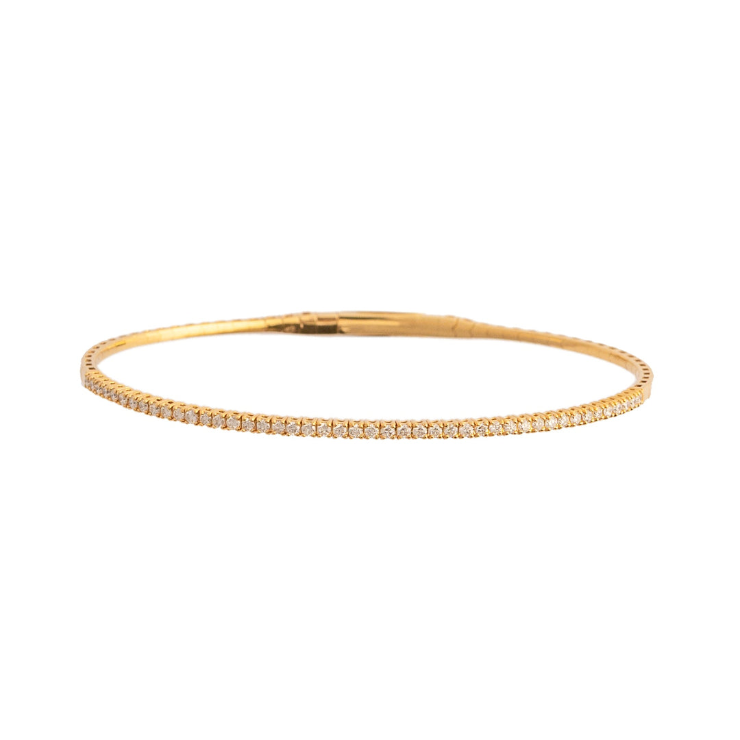 A gold flexible bracelet with diamonds on a white background.