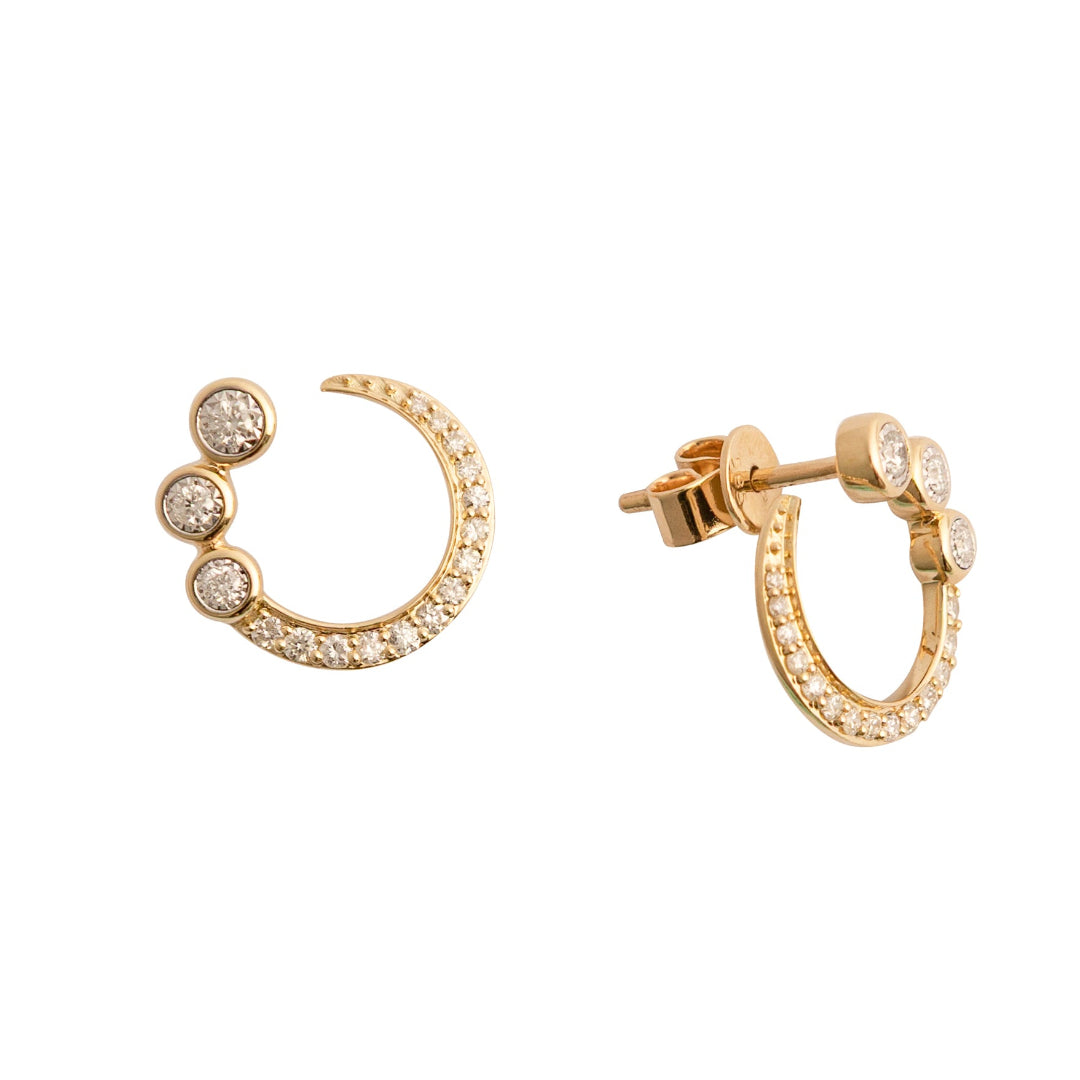 Gold stud earrings with embedded stones on a white background