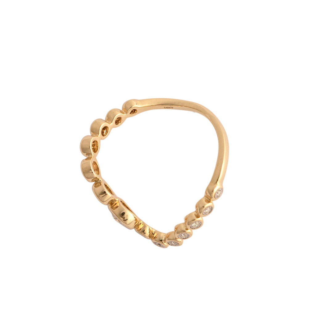 Gold ring with diamonds in a curved design on a white background.