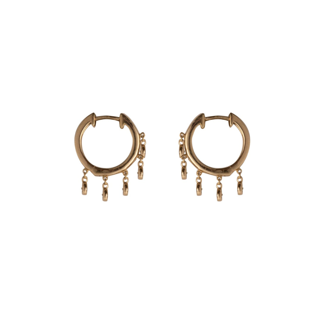 A pair of gold hoops with dangling bezel set diamonds on a white background.