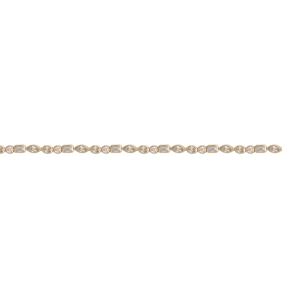 A tennis bracelet with lab-grown diamonds bezel set in 14k gold, featuring a series of connected gold circles with diamond accents.
