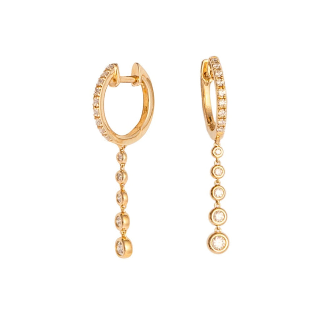 Gold hoop earrings with dangling beads on a white background