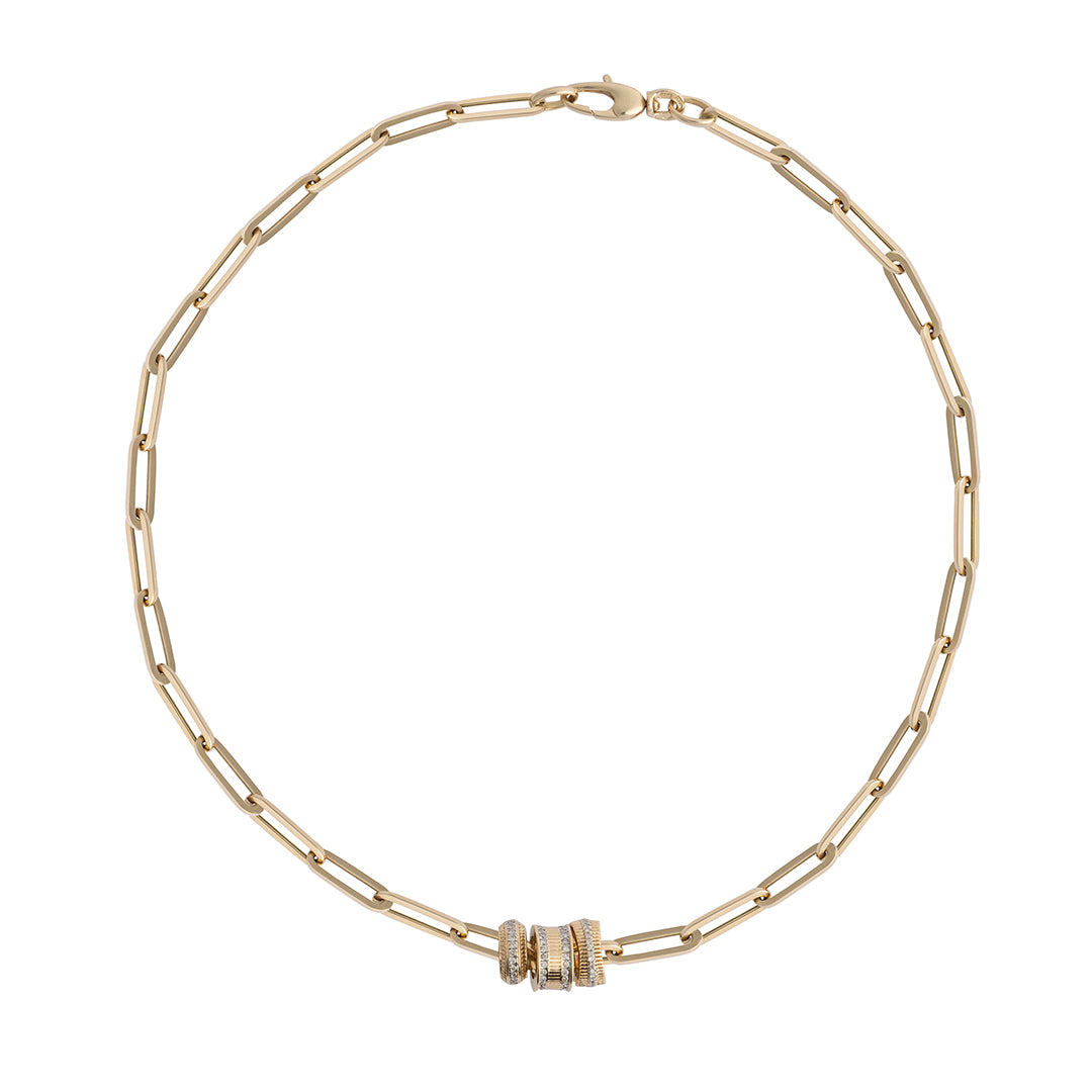 A paperclip chain with three gold and diamond roundel beads on a white background.