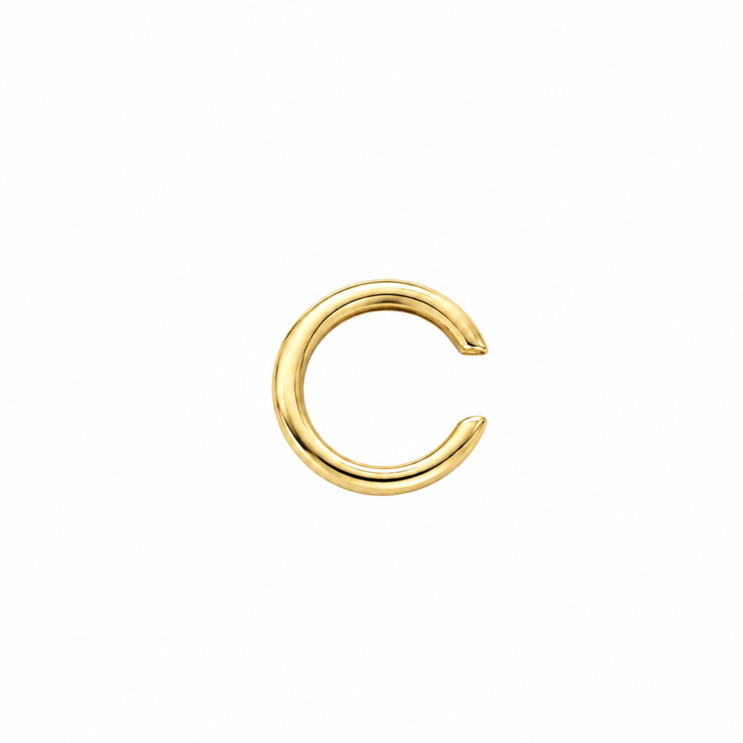 A 14k gold ear cuff on a white background.