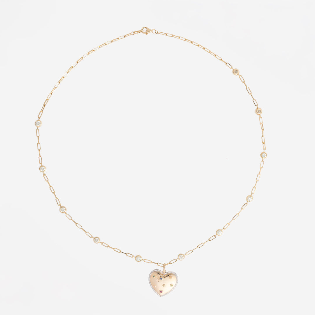 Gold necklace with a heart-shaped pendant on a white background