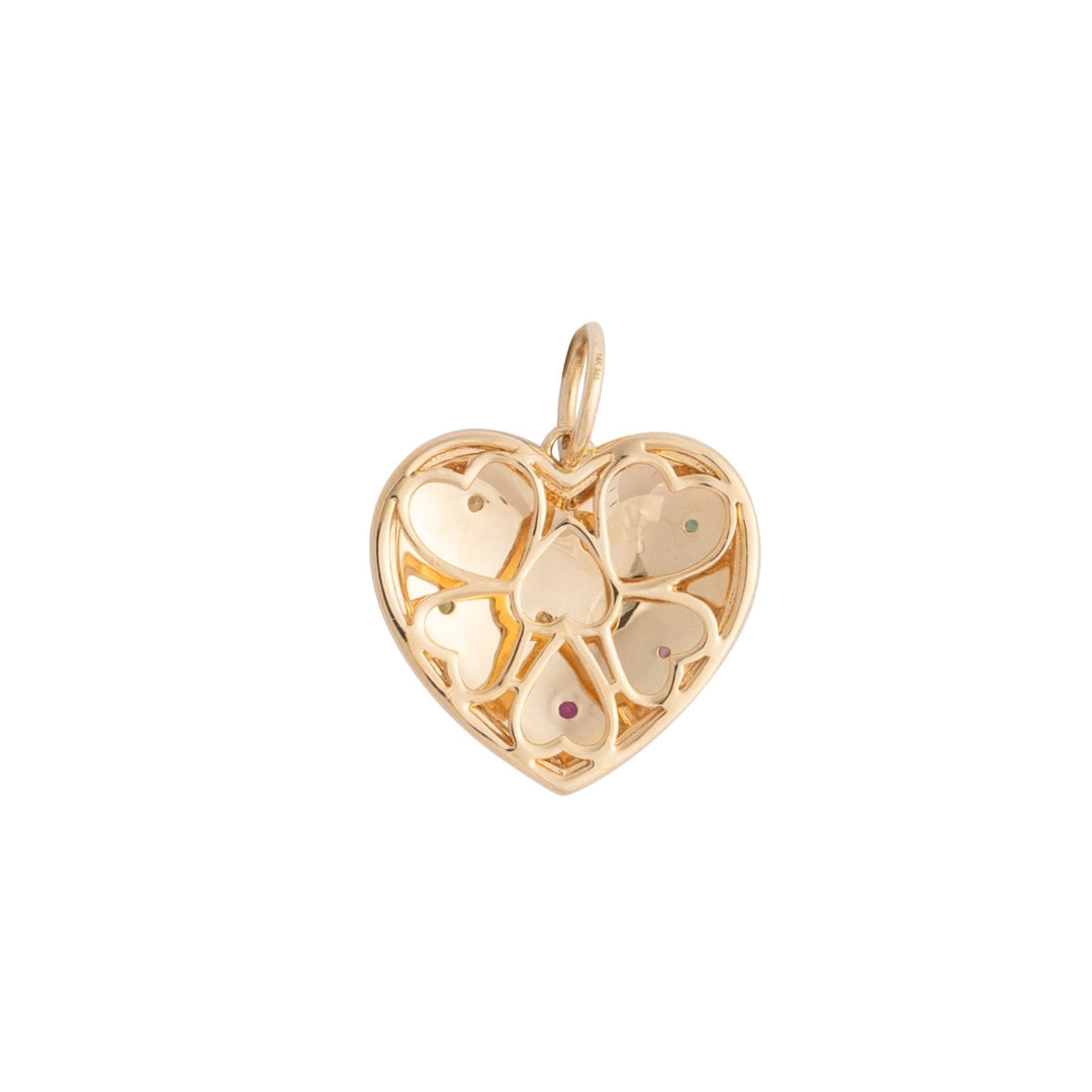 The back of a gold heart-shaped pendant on a white background