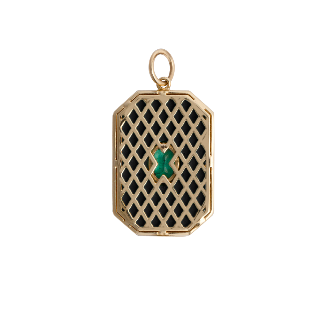 The back of a pendant with a 14k gold lattice design set on a white background.