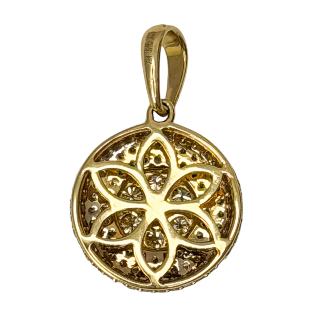Gold pendant with intricate design on a white background
