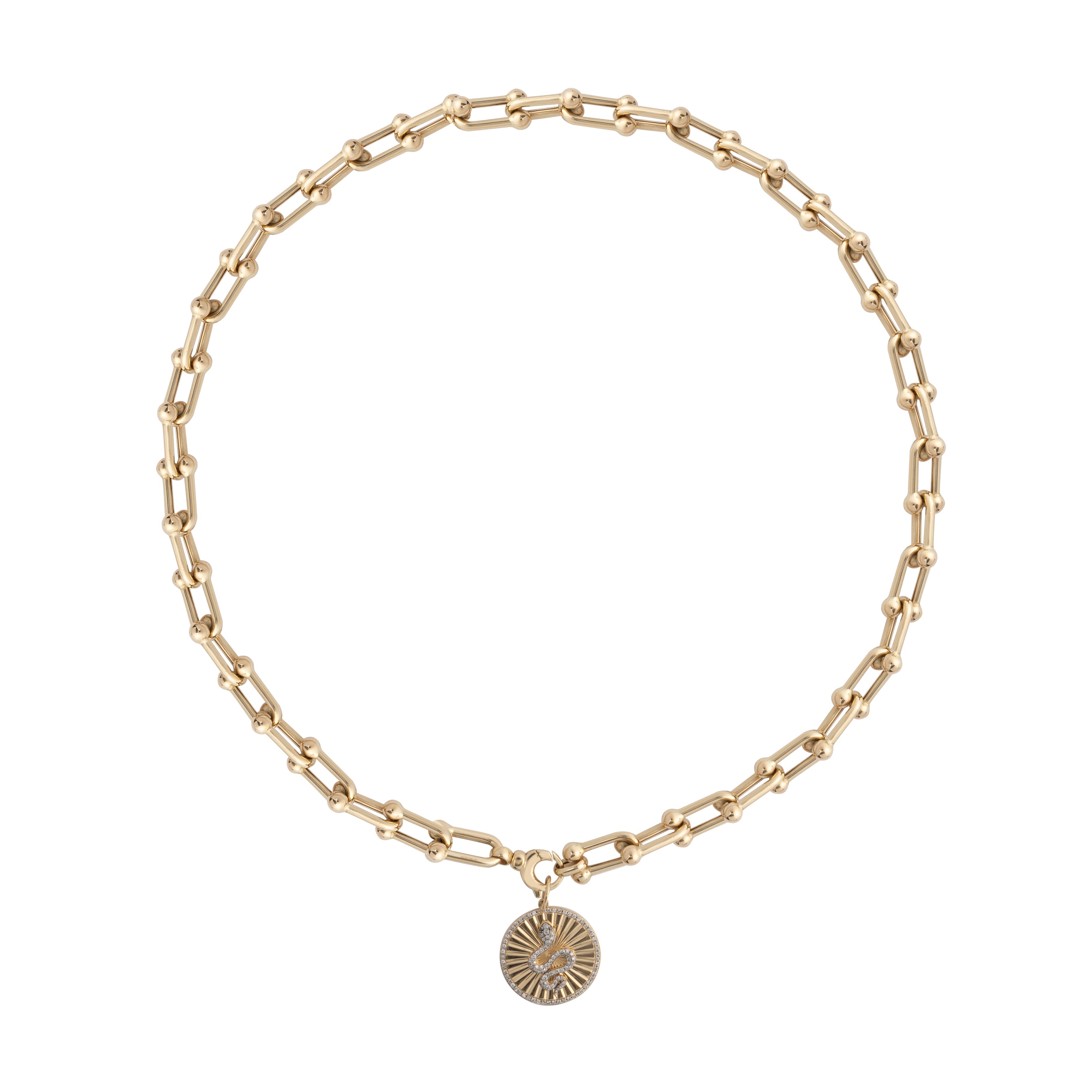 A white background with a a chunky u-link 14k gold necklace layered a diamond serpent pendant attached.