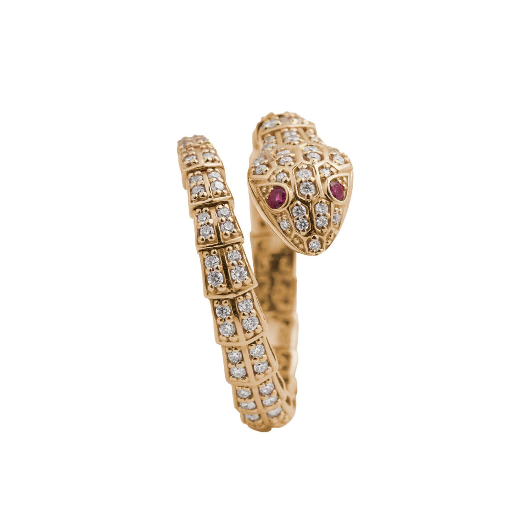 A sideways view of a serpent ring encrusted in diamonds with ruby eyes.