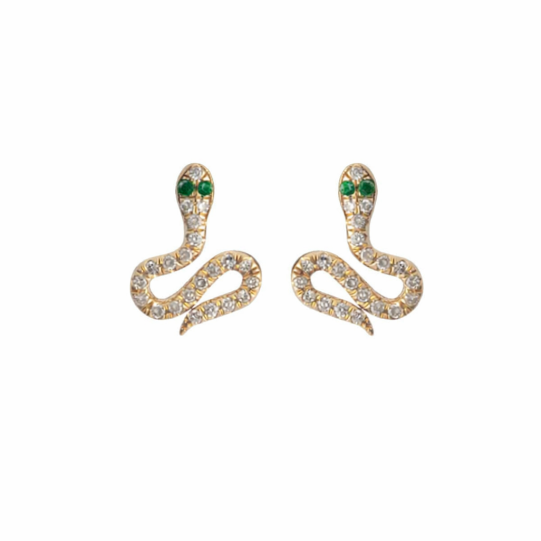 Gold snake-shaped earrings with pave diamonds and emerald eyes on a white background