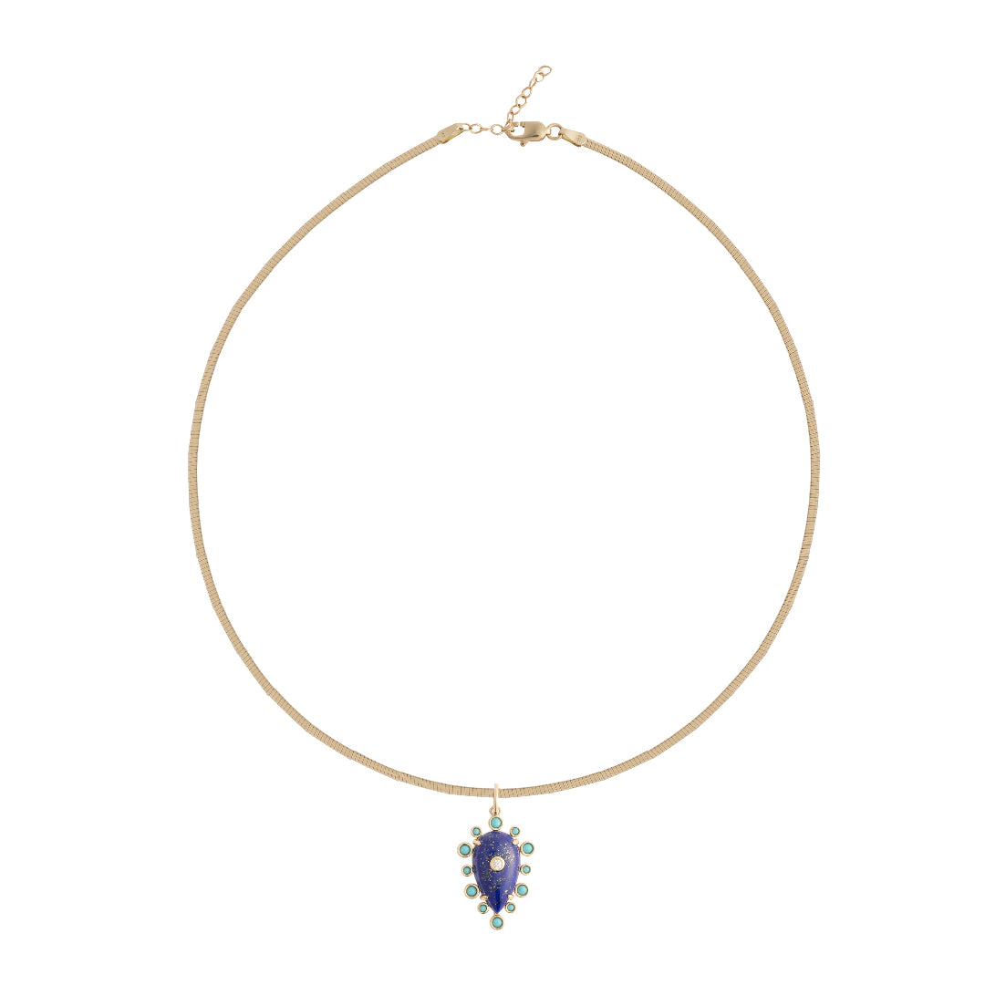 Gold necklace with a blue teardrop pendant on a white background