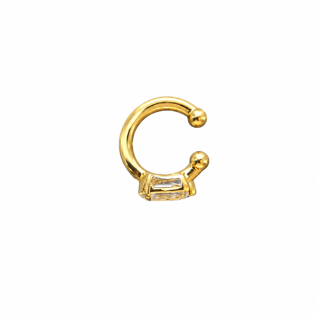 A 14k gold ear cuff with a .75 carat lab-grown diamond on a white background.