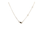 The back of a 14k gold delicate chain, with a lobster clasp and three stations. 