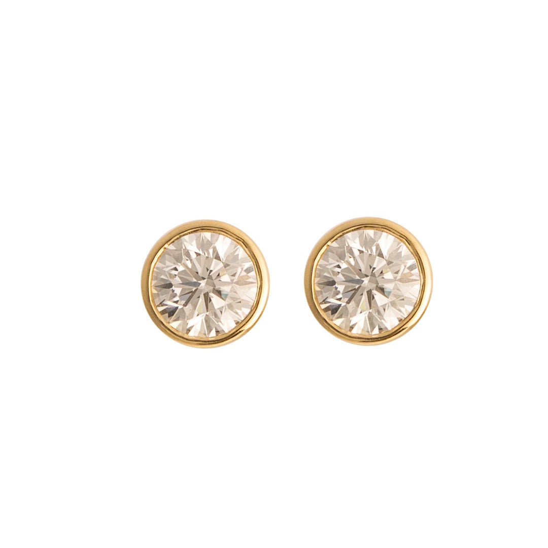 Gold stud earrings with diamonds gemstones on a white background