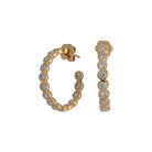 A pair of bezel set round lab-grown diamond C hoop earrings in 14k gold.