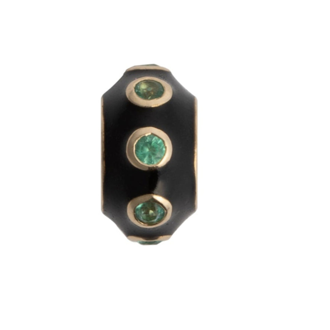A black enamel and emerald roundel bead with gold accents, designed to be used as a charm or pendant.