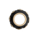 Black and gold bead on a white background