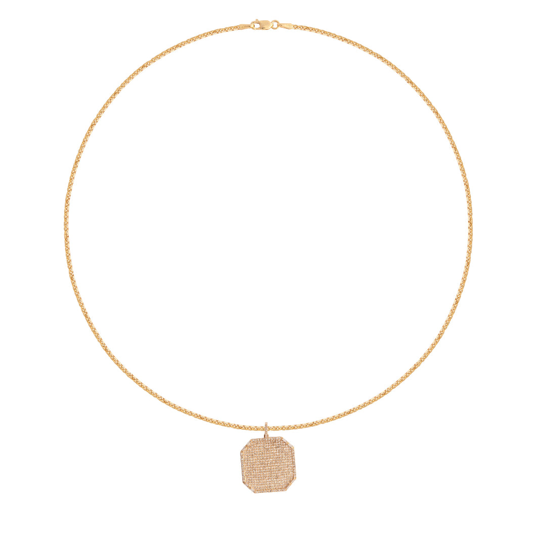 Gold necklace with a diamond pave pendant on a white background